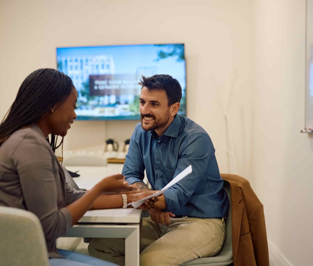 happy-colleagues-analyzing-busines-reports-in-crea-2024-12-13-18-37-12-utc-2