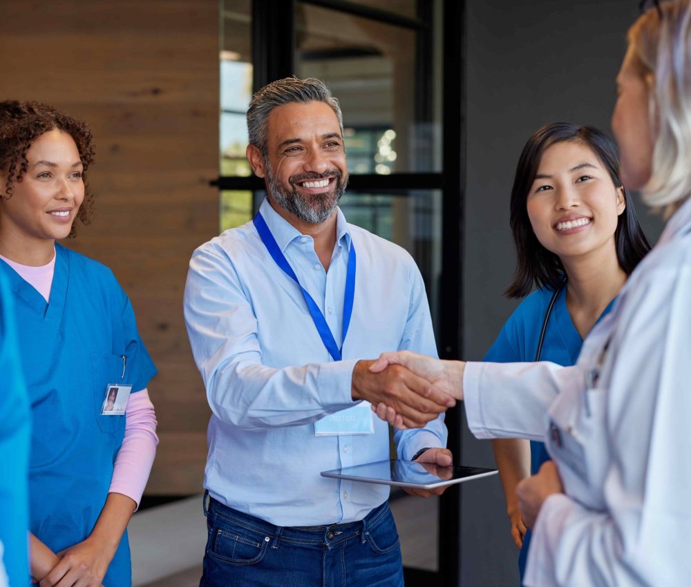 mature-woman-doctor-shaking-hands-with-pharmaceuti-2025-01-10-04-29-29-utc-2